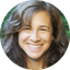 Smiling woman with brown hair in circular portrait