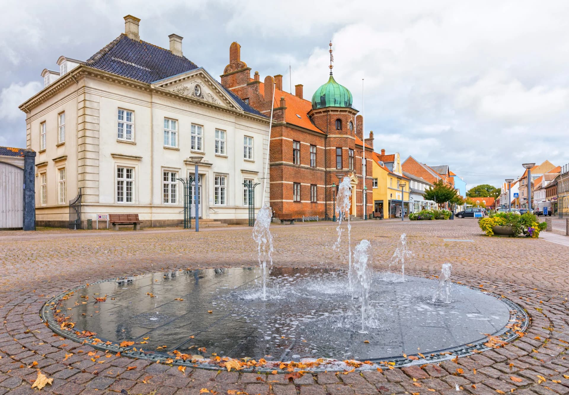 Town square at Stege on the island of Møn, Denmark, with fountain, town hall and historic savings bank